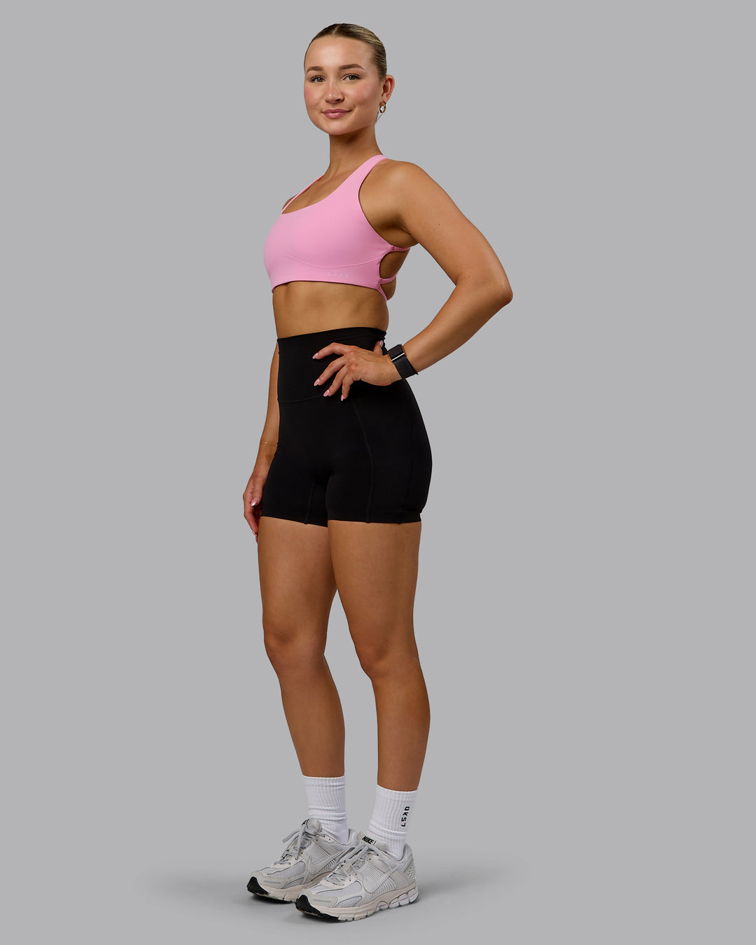 Woman wearing Aspire Sports Bra - Bubblegum - view 3