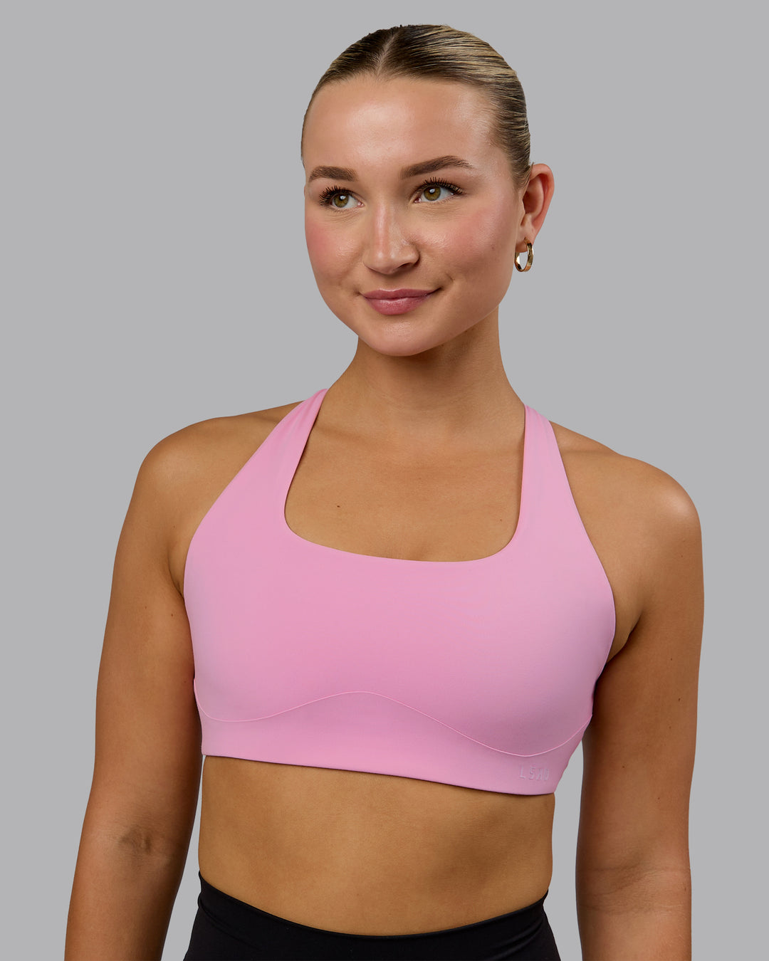 Woman wearing Aspire Sports Bra - Bubblegum - view 2