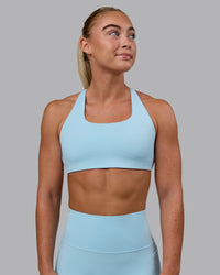 Woman wearing Aspire Sports Bra - Glacial Blue | Thumbnail Index: 1