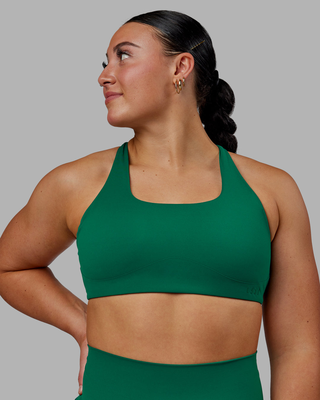 Woman wearing Aspire Sports Bra - Malachite - view 2