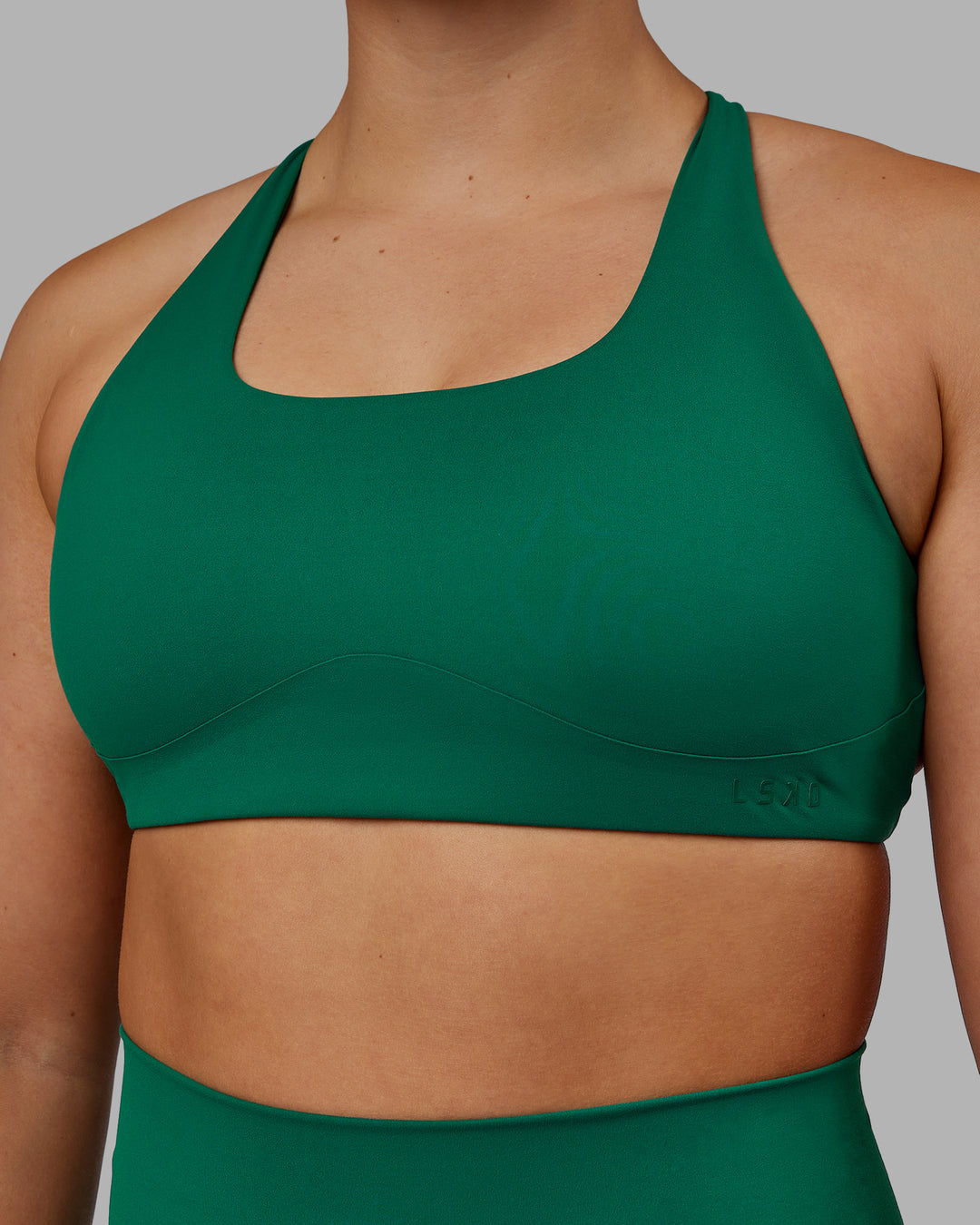 Woman wearing Aspire Sports Bra - Malachite - view 5