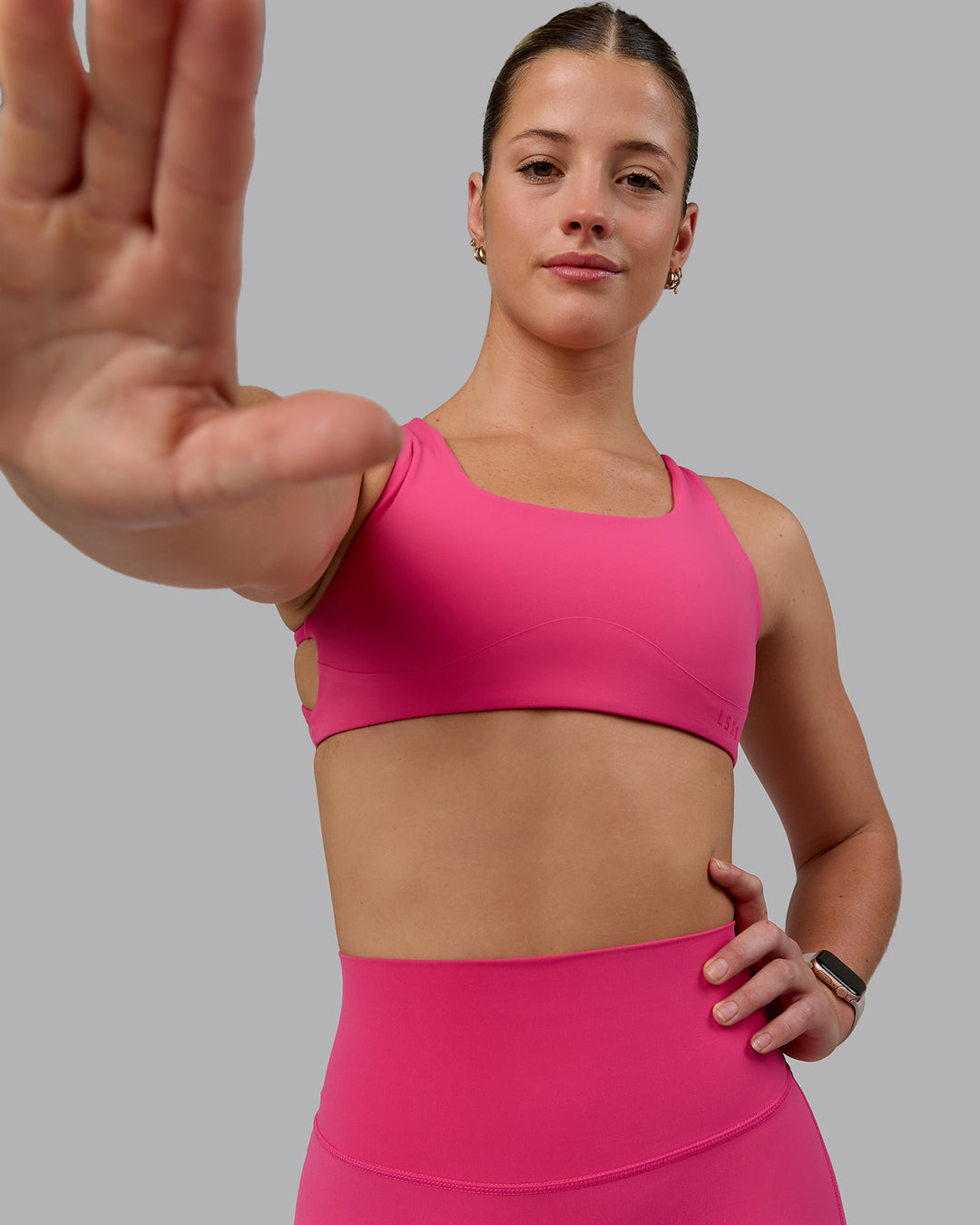 Woman wearing Aspire Sports Bra - Pink Flash - view 3