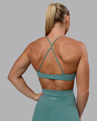 Woman wearing Aura Sports Bra - Sagebrush | Thumbnail Index: 1