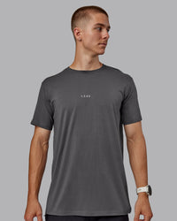 Man wearing Base FLXCotton Tee - Dark Storm | Thumbnail Index: 0