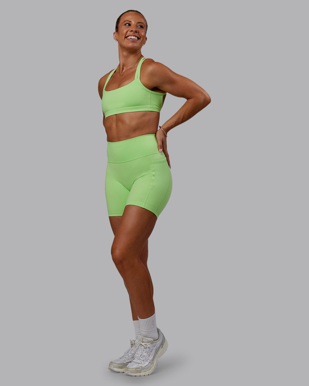 Woman wearing Bree Masters Fusion Ultra High-Rise 6" Short Pockets - Pastel Lime - view 10