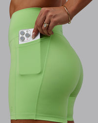 Woman wearing Bree Masters Fusion Ultra High-Rise 6" Short Pockets - Pastel Lime | Thumbnail Index: 2