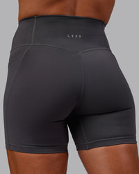Woman wearing Bree Masters Fusion Ultra High-Rise 6" Short Pockets - Stormy | Thumbnail Index: 2