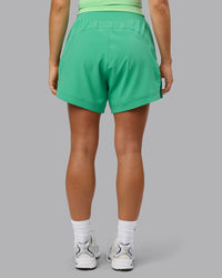 Woman wearing Challenger 5" Lined Performance Shorts - Mystic Green | Thumbnail Index: 4