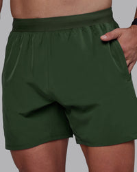 Man wearing Challenger 6" Performance Shorts - Cilantro | Thumbnail Index: 1