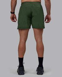 Man wearing Challenger 6" Performance Shorts - Cilantro | Thumbnail Index: 3