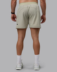 Man wearing Challenger 6" Performance Shorts - Sustained Grey | Thumbnail Index: 3