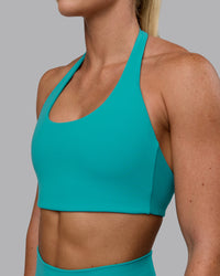 Woman wearing Challenger Sports Bra - Uplift Blue | Thumbnail Index: 3