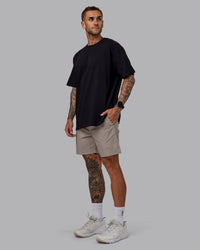 Man wearing Daily 7" Shorts - Shale Beige | Thumbnail Index: 1