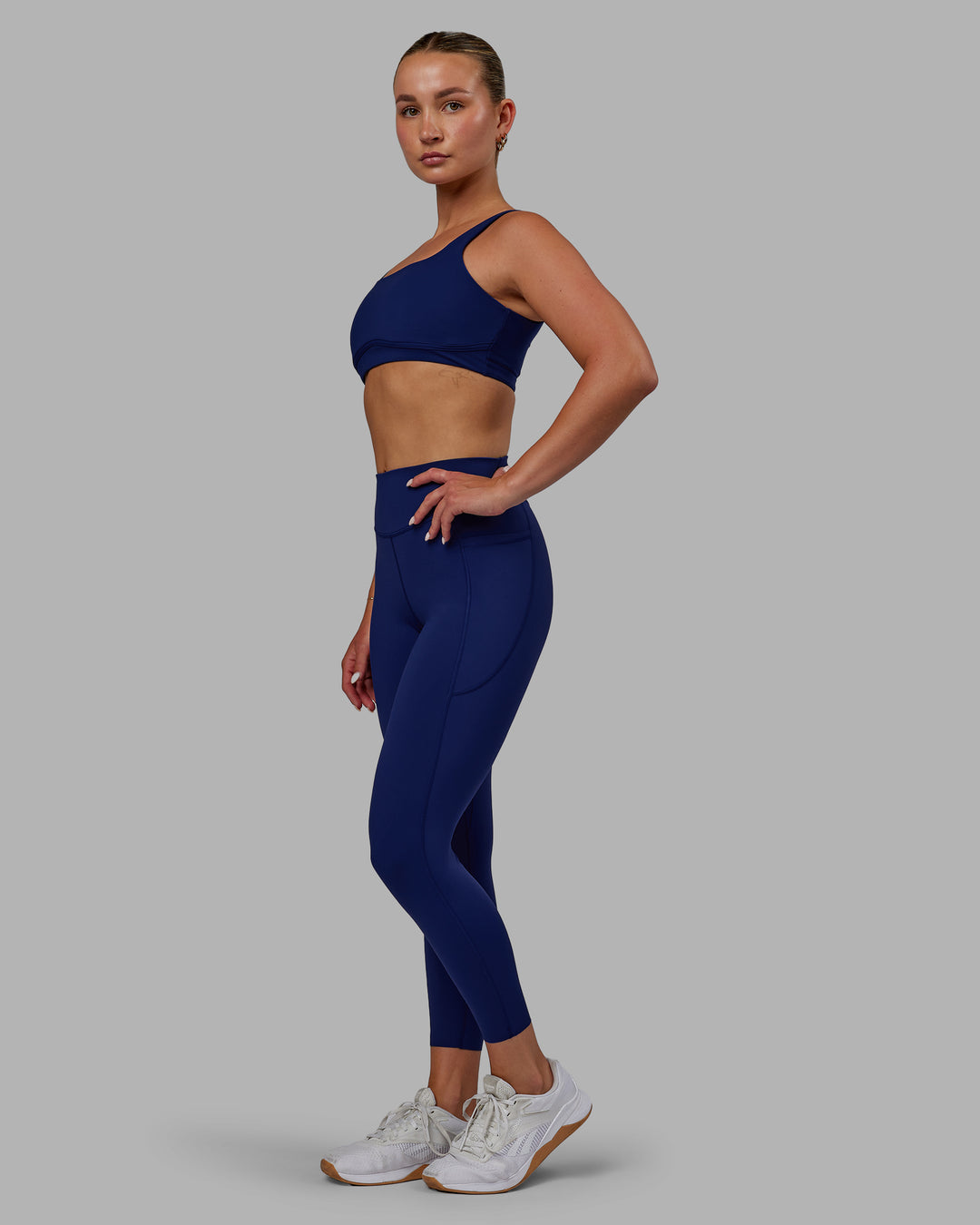 Woman wearing Elite High-Rise 7/8 Legging Pockets - Midnight Blue - view 7