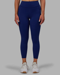 Woman wearing Elite High-Rise 7/8 Legging Pockets - Midnight Blue | Thumbnail Index: 0