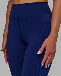 Woman wearing Elite High-Rise 7/8 Legging Pockets - Midnight Blue | Thumbnail Index: 5