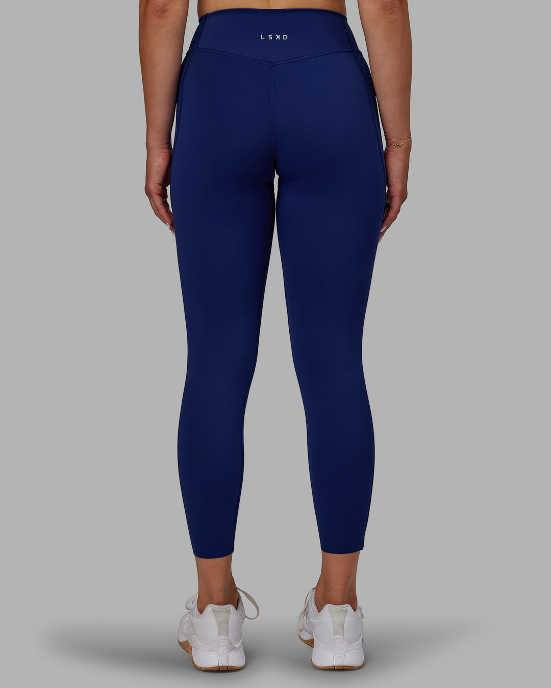 Woman wearing Elite High-Rise 7/8 Legging Pockets - Midnight Blue - view 4