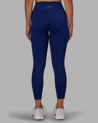 Woman wearing Elite High-Rise 7/8 Legging Pockets - Midnight Blue | Thumbnail Index: 3