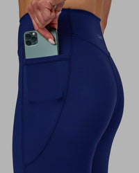 Woman wearing Elite High-Rise 7/8 Legging Pockets - Midnight Blue | Thumbnail Index: 7