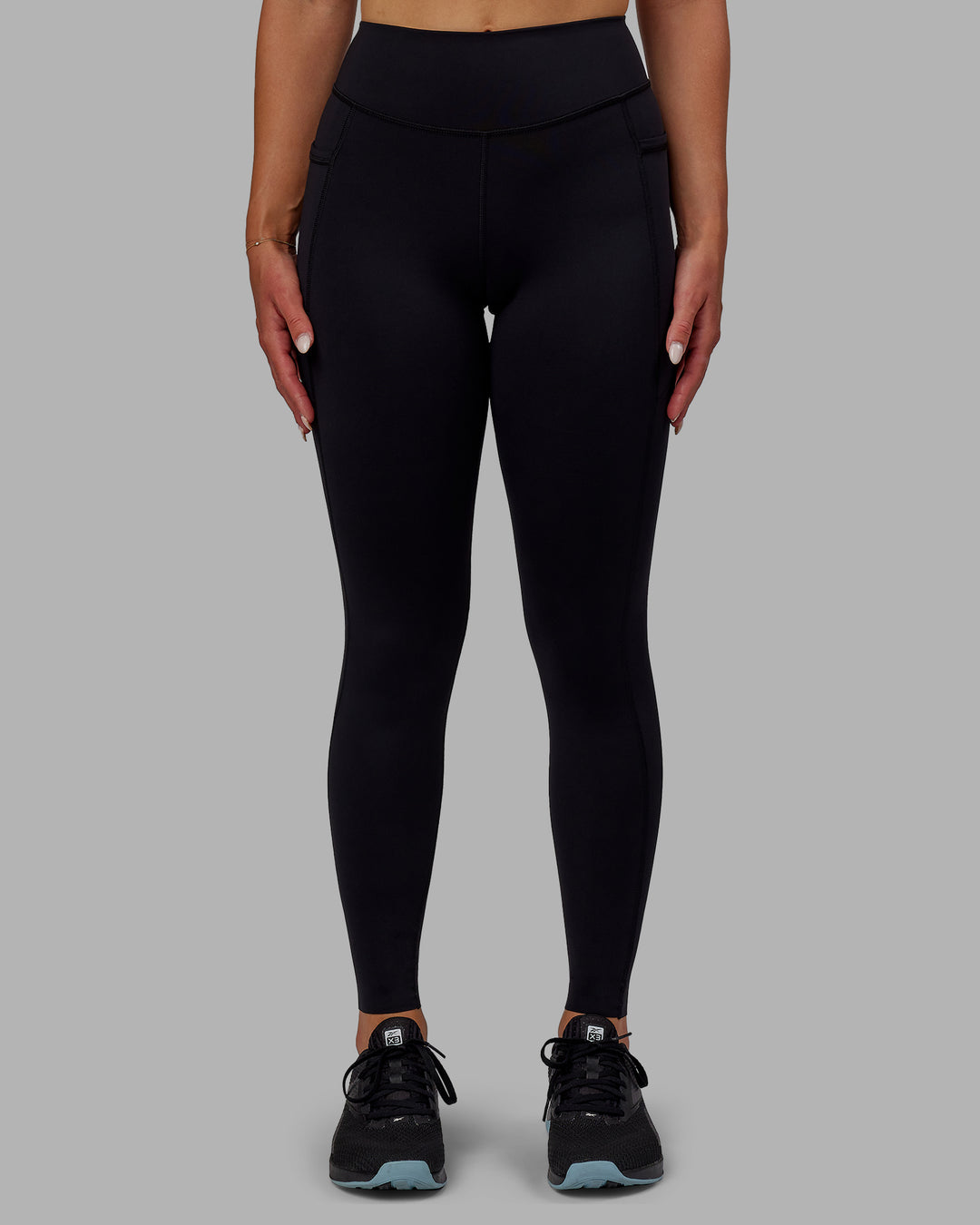 Woman wearing Elite High-Rise Full Length Legging Pockets - Black - view 1