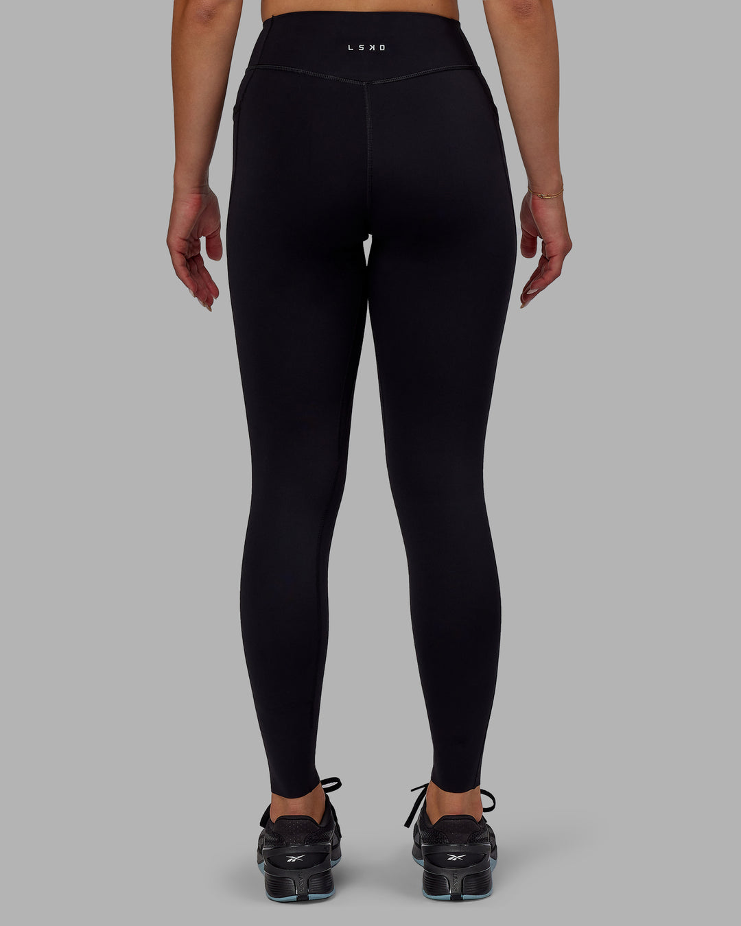 Woman wearing Elite High-Rise Full Length Legging Pockets - Black - view 4