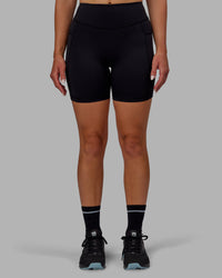 Woman wearing Elite High-Rise 6" Short Pockets - Black | Thumbnail Index: 9