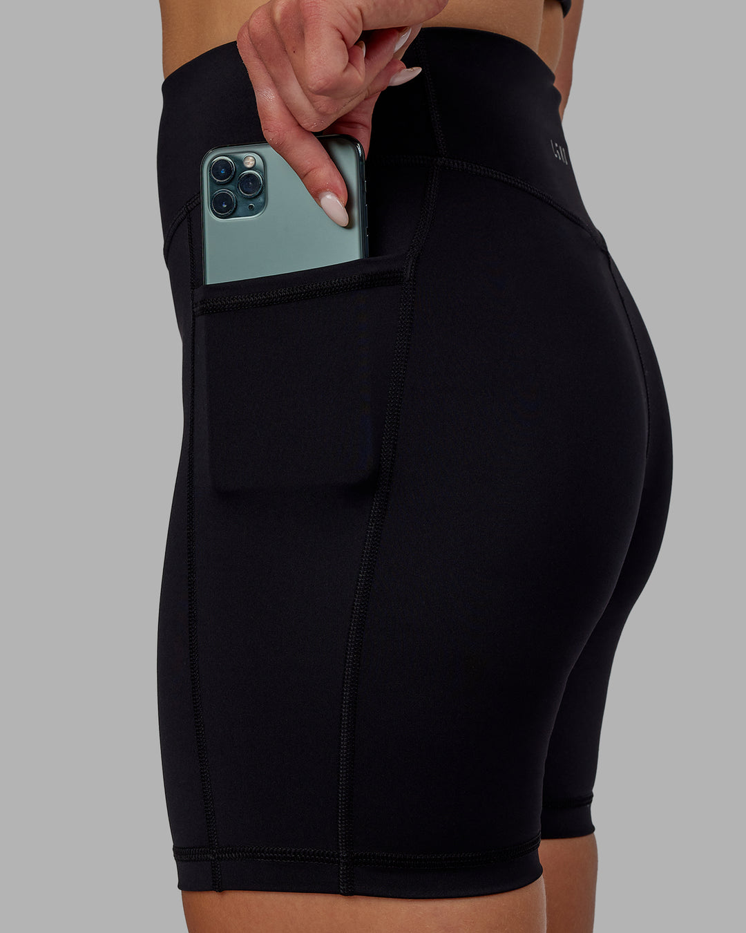 Woman wearing Elite High-Rise 6" Short Pockets - Black - view 1