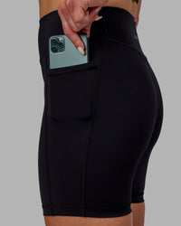 Woman wearing Elite High-Rise 6" Short Pockets - Black | Thumbnail Index: 0