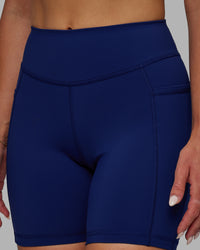 Woman wearing Elite High-Rise 6" Short Pockets - Midnight Blue | Thumbnail Index: 4