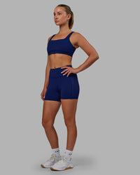 Woman wearing Elite High-Rise 4" Short Pockets - Midnight Blue | Thumbnail Index: 1
