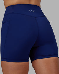 Woman wearing Elite High-Rise 4" Short Pockets - Midnight Blue | Thumbnail Index: 7