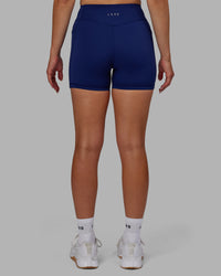 Woman wearing Elite High-Rise 4" Short Pockets - Midnight Blue | Thumbnail Index: 2