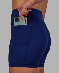 Woman wearing Elite High-Rise 4" Short Pockets - Midnight Blue | Thumbnail Index: 6