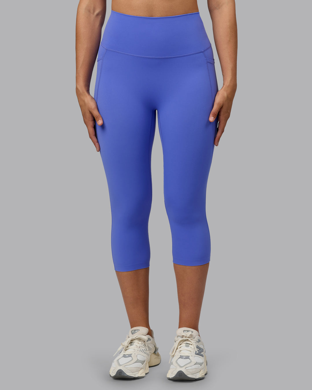 Woman wearing Elixir Ultra High-Rise 3/4 Legging Pockets - Baja Blue | Model:Sophie | Size:S - view 1