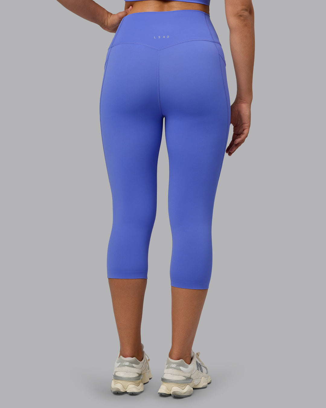 Woman wearing Elixir Ultra High-Rise 3/4 Legging Pockets - Baja Blue | Model:Sophie | Size:S - view 4