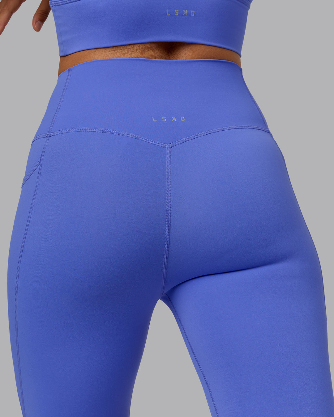 Woman wearing Elixir Ultra High-Rise 3/4 Legging Pockets - Baja Blue | Model:Sophie | Size:S - view 8