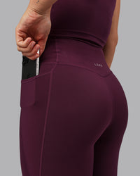Woman wearing Elixir Ultra High-Rise 7/8 Legging Pockets - Cherry Lacquer | Model:Lyss | Size:S | Thumbnail Index: 4