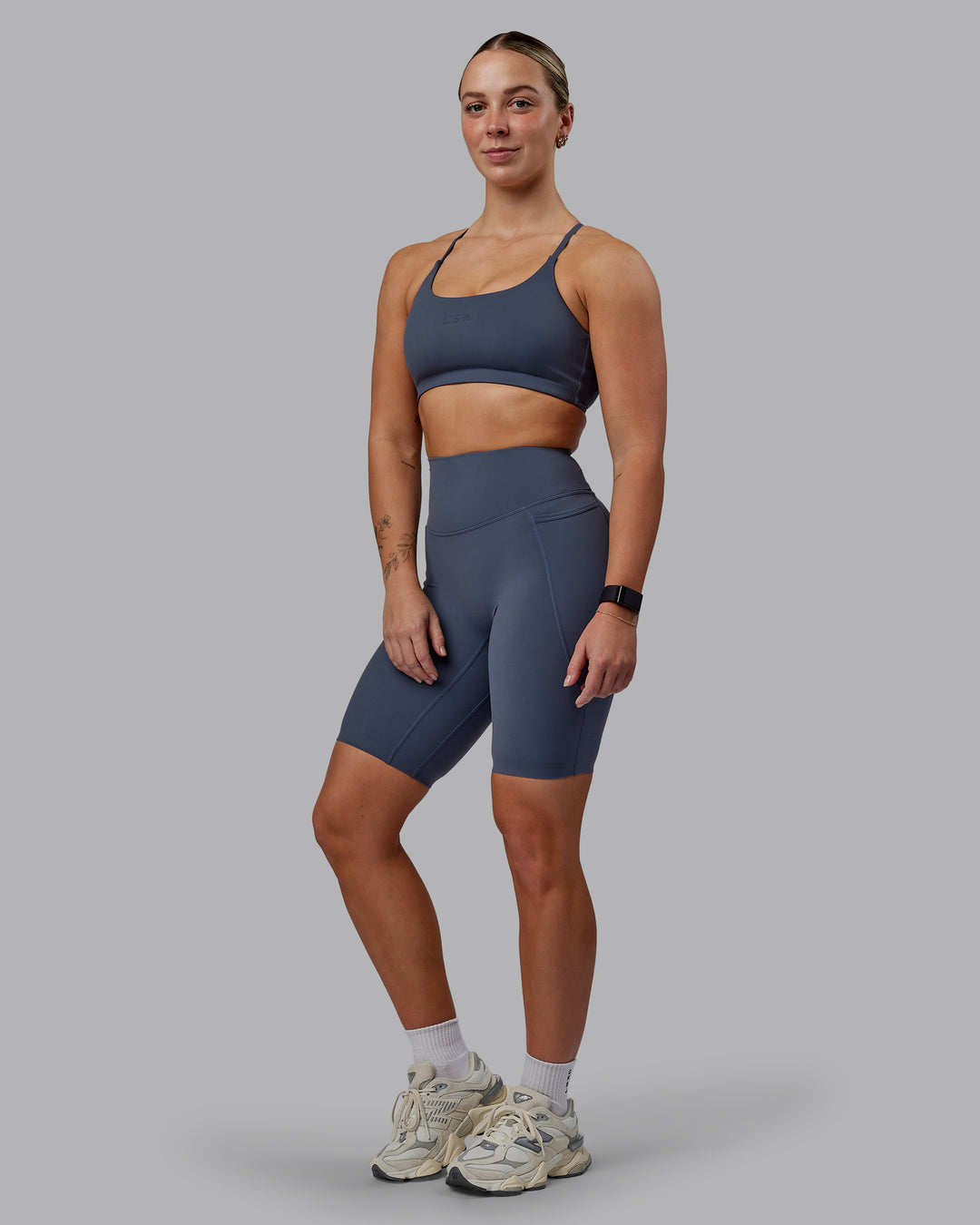 Woman wearing Elixir Ultra High-Rise 9" Short Pockets - Turbulence | Model:Suz | Size:S - view 1