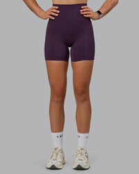 Woman wearing Elixir Ultra High-Rise 6" Short Pockets - Midnight Plum | Thumbnail Index: 0