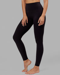 Woman wearing Elixir Ultra High-Rise Tall Legging - Black | Thumbnail Index: 1