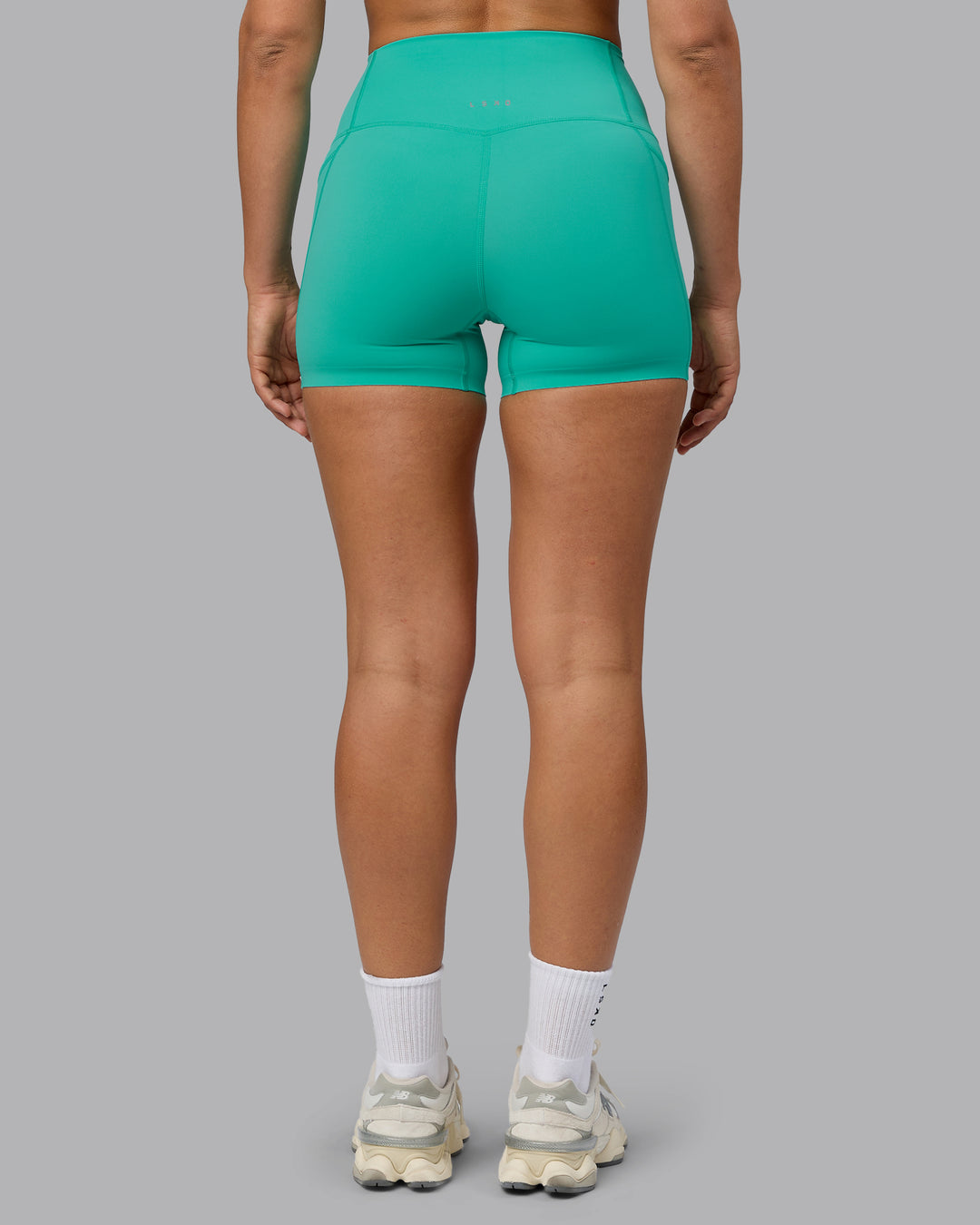Woman wearing Elixir Ultra High-Rise 4" Short Pockets - Atlantis | Model:Sophie | Size:S - view 3