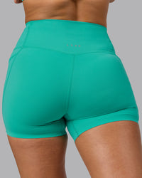 Woman wearing Elixir Ultra High-Rise 4" Short Pockets - Atlantis | Model:Sophie | Size:S | Thumbnail Index: 8