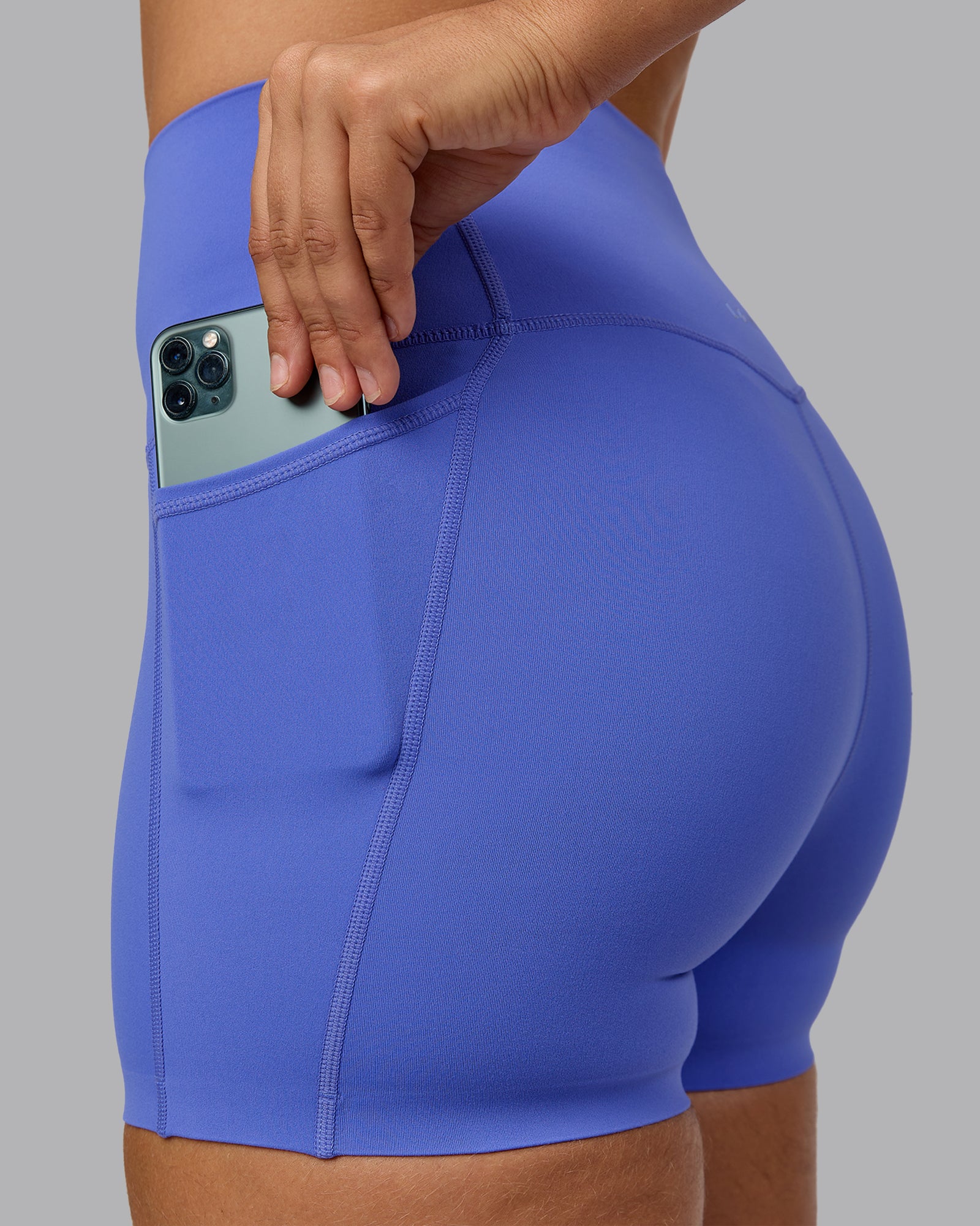 Woman wearing Elixir Ultra High-Rise 4" Short Pockets - Baja Blue | Model:Sophie | Size:S