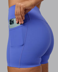Woman wearing Elixir Ultra High-Rise 4" Short Pockets - Baja Blue | Model:Sophie | Size:S | Thumbnail Index: 1