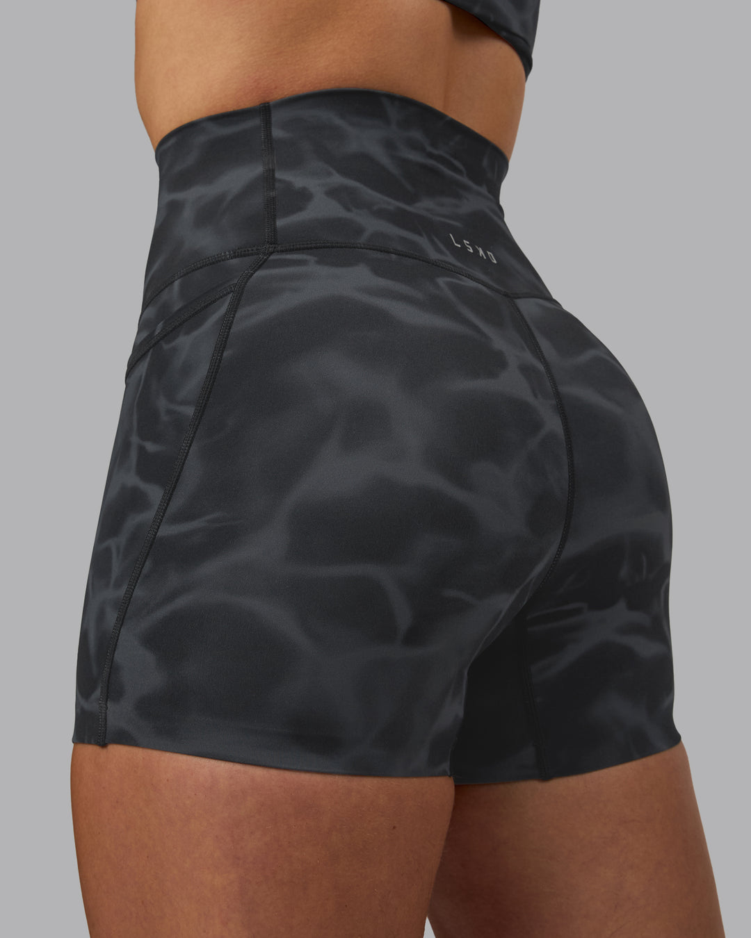 Woman wearing Elixir Ultra High-Rise 4" Short Pockets - Tranquil-Black | Model:Robyn | Size:S - view 7