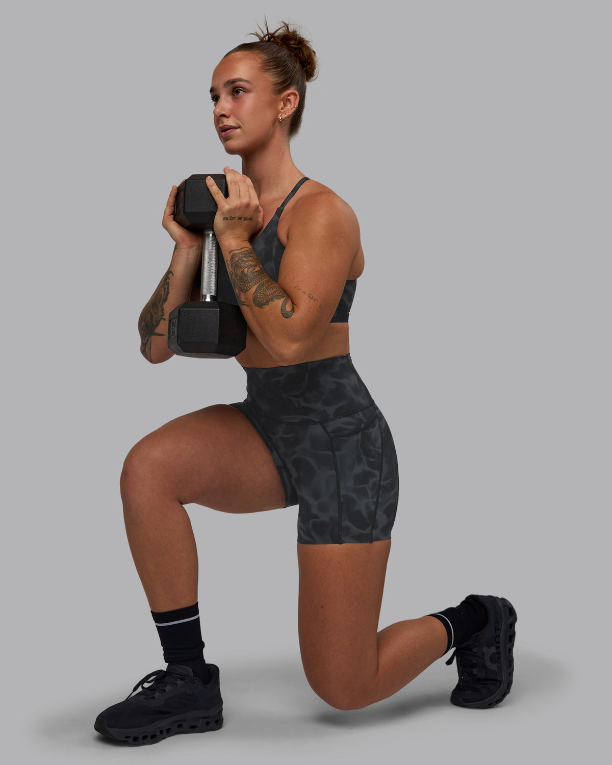 Woman wearing Elixir Ultra High-Rise 4" Short Pockets - Tranquil-Black | Model:Robyn | Size:S