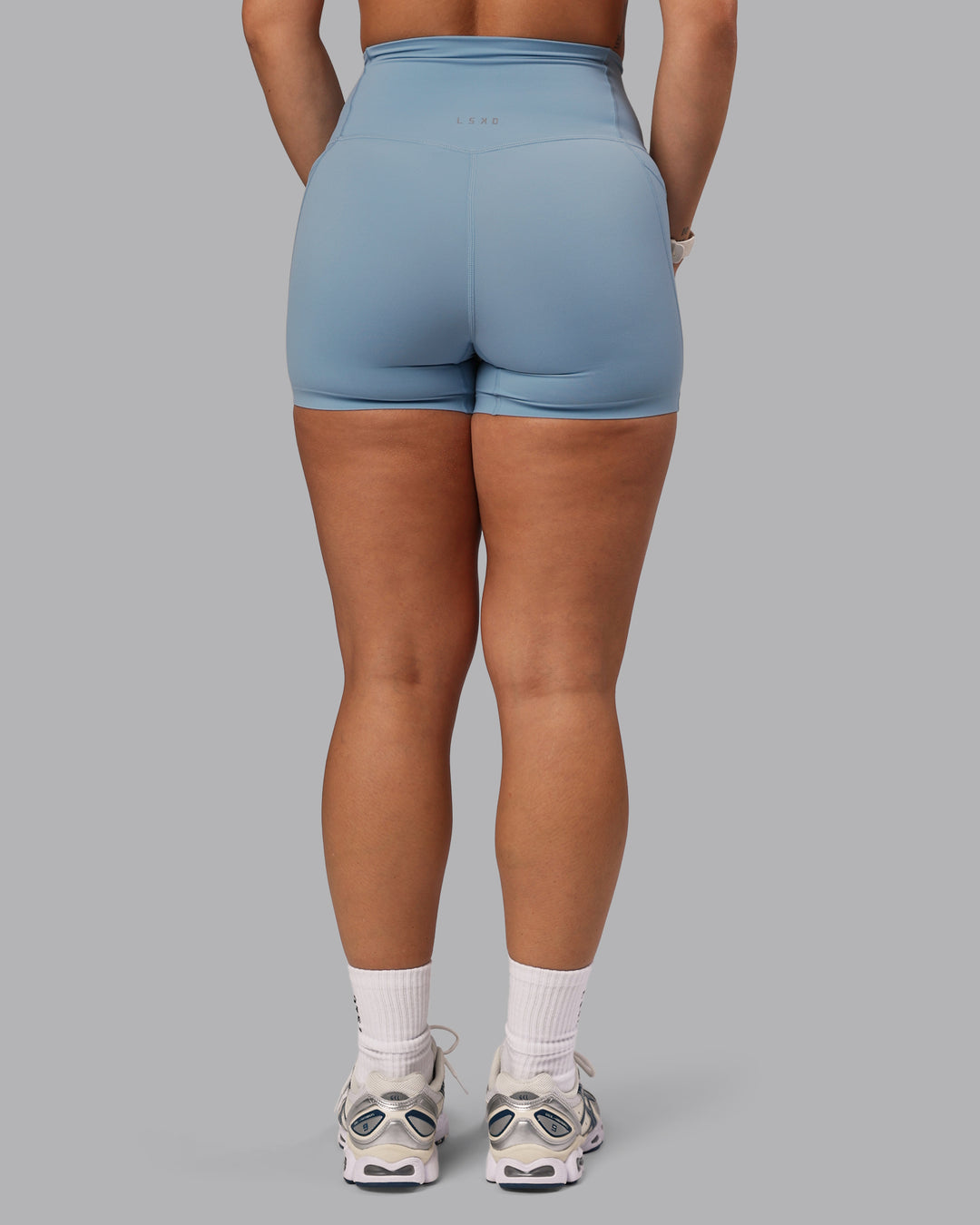 Woman wearing Elixir Ultra High-Rise 4" Short Pockets - Glacier Lake | Model:Lyss | Size:S - view 4