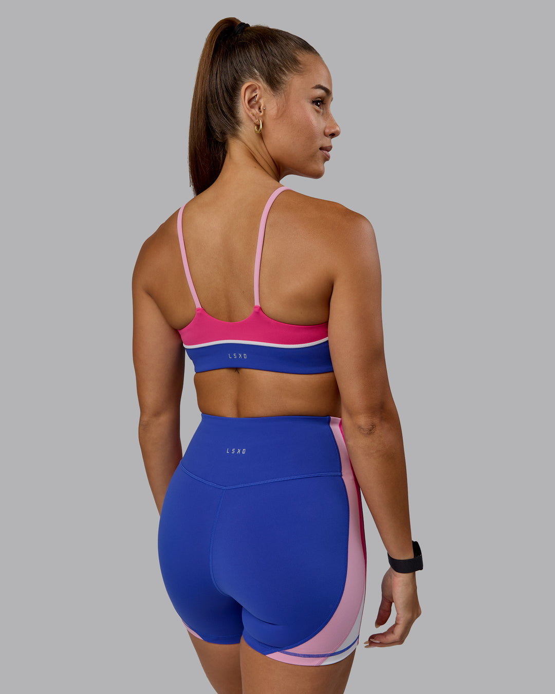 Woman wearing Embrace Sports Bra - Power Cobalt-Fuchsia Pink - view 2