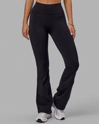 Woman wearing Fusion Ultra High-Rise Flared Legging Pockets - Black | Model:Milly | Size:S | Thumbnail Index: 7