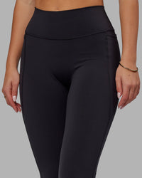 Woman wearing Fusion Ultra High-Rise Flared Legging Pockets - Black | Model:Milly | Size:S | Thumbnail Index: 6